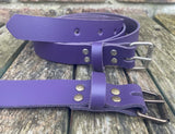 Plain leather 25mm wide belt with perforated steel or old brass roller buckle. Choice of 13 colours