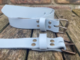 Plain leather 25mm wide belt with perforated steel or old brass roller buckle. Choice of 13 colours