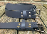 Plain leather 25mm wide belt with perforated steel or old brass roller buckle. Choice of 13 colours