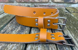 Plain leather 25mm wide belt with perforated steel or old brass roller buckle. Choice of 13 colours