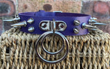 Double spiked D & o-ring leather choker approx 25mm wide. Choice of ring and spike size