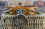Double spiked D & o-ring leather choker approx 25mm wide. Choice of ring and spike size