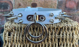 Double spiked D & o-ring leather choker approx 25mm wide. Choice of ring and spike size