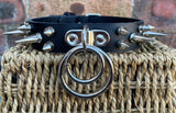Double spiked D & o-ring leather choker approx 25mm wide. Choice of ring and spike size