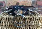 Double spiked D & o-ring leather choker approx 25mm wide. Choice of ring and spike size
