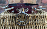 Double spiked D & o-ring leather choker approx 25mm wide. Choice of ring and spike size